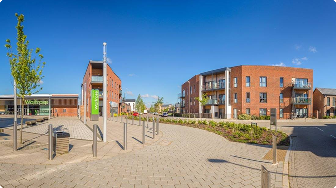 Modern residential complex with Waitrose store entrance.