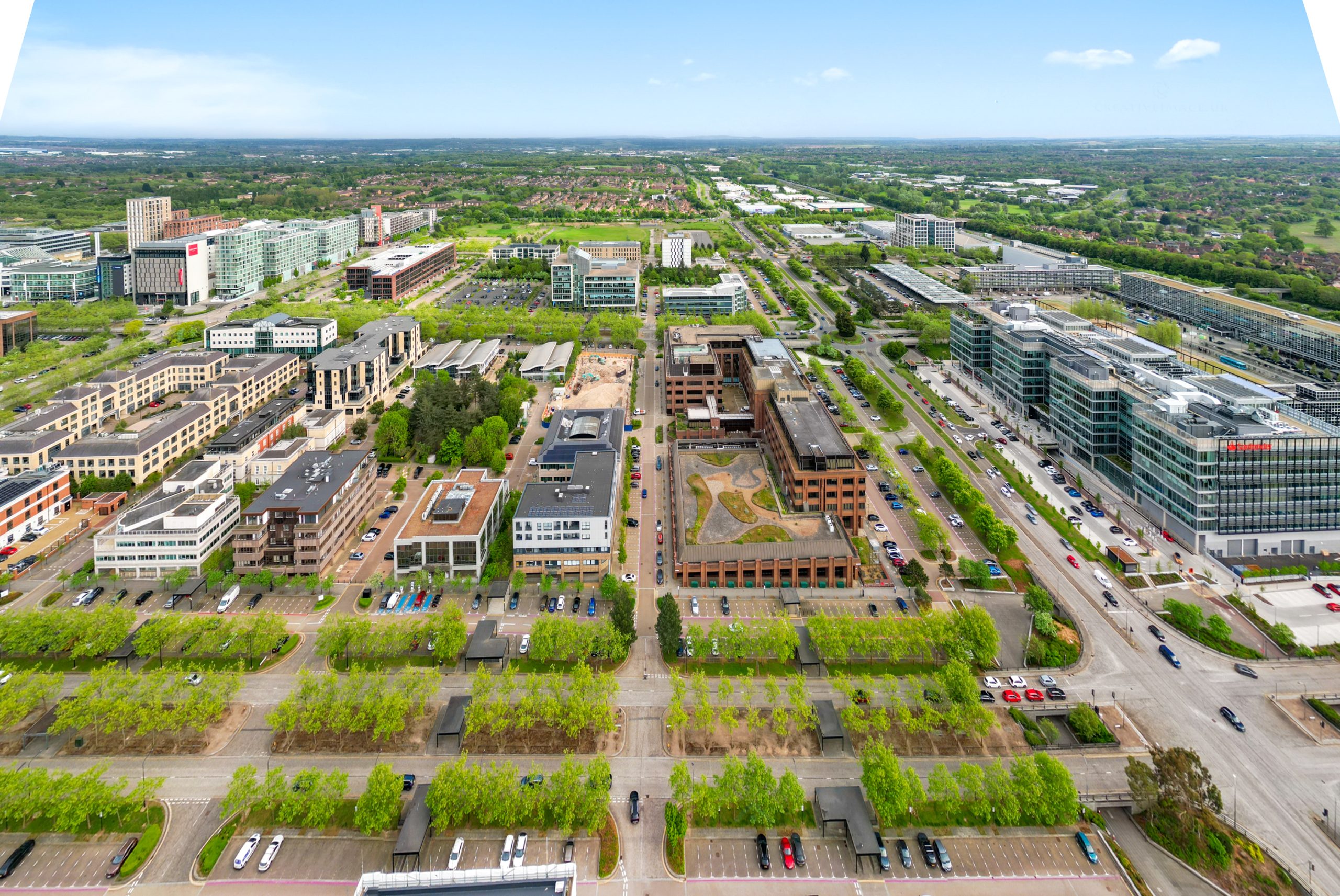 Aerial view of modern business district with greenery.