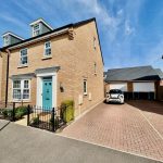 Modern brick house with blue door and driveway
