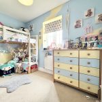 Colourful children's bedroom with bunk bed and toys.