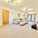 Spacious living room with sofa and modern decor.