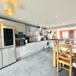 Modern kitchen and dining area with open layout.