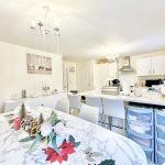 Modern kitchen with festive table decorations.