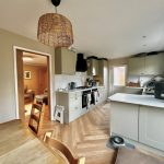 Modern kitchen with wooden dining table and chairs.