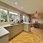 Spacious kitchen with modern design and dining area.