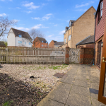Residential garden with patio and fence.