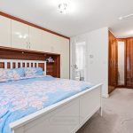 Modern bedroom with built-in wardrobes and desk