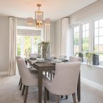 Elegant dining room with modern decor and large windows.