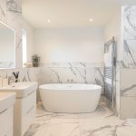 Modern marble bathroom with bathtub and double sink
