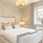 Luxurious bedroom with elegant decor and bedside lamps.