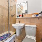 Modern bathroom with shower, sink, and toilet