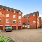 Red brick residential buildings with a parked van.