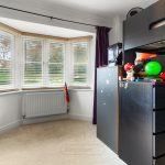 Child's bedroom with bright window and toys.
