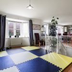 Home gym with dartboard and exercise mat