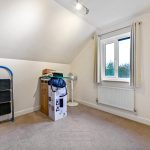 Unfurnished room with window and storage items.