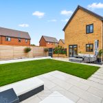 Modern house with landscaped garden and patio.