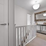 Modern hallway with decorative mirror and console table.