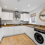 Modern white kitchen with wooden accents