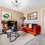 Stylish living room with orange sofa and artwork.