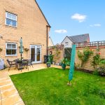 Sunny garden with patio furniture and plants