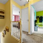 Bright hallway with doors to colourful rooms.