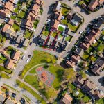 Aerial view of suburban houses and park.