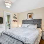 Cosy bedroom with double bed and modern decor.