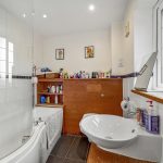 Modern bathroom with vanity and bathtub.