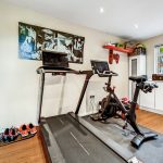Home gym with treadmill and exercise bike.