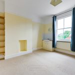Empty room with window, shelves, and sink
