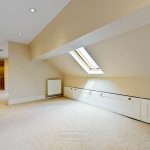 Spacious loft room with skylight and storage.