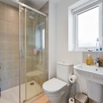 Modern bathroom with shower, toilet, and sink