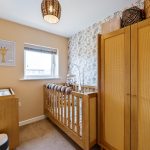 Stylish nursery with cot and changing table.