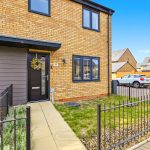 Modern brick house with black doors and car