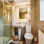 Modern bathroom with shower, sink, and toilet