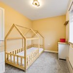 Children's bedroom with house-shaped bed.