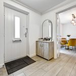 Entrance hall with view into dining area.