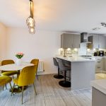 Modern kitchen with dining area and stylish decor.