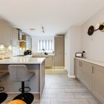 Modern kitchen with island and bar stools.