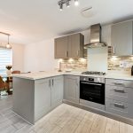 Modern kitchen with grey cabinets and dining area