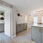 Modern kitchen with utility room and island counter