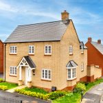 Modern suburban brick house on a sunny day.
