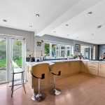 Modern kitchen with garden view and wooden counters.