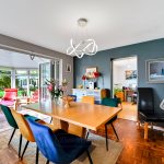 Spacious dining area with vibrant chairs and decor.