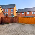 Modern terraced houses with fenced garden area.