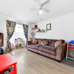 Bright living room with sofa and toys.