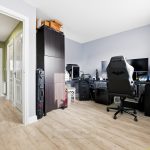 Home office setup with multiple computer screens.