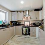 Modern kitchen with appliances and white cabinets