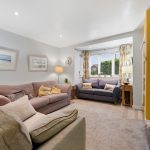 Bright living room with cosy sofas and large window.