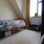 Children's bedroom with superhero-themed bedspread